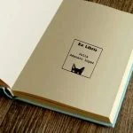 Cat looking book stamp